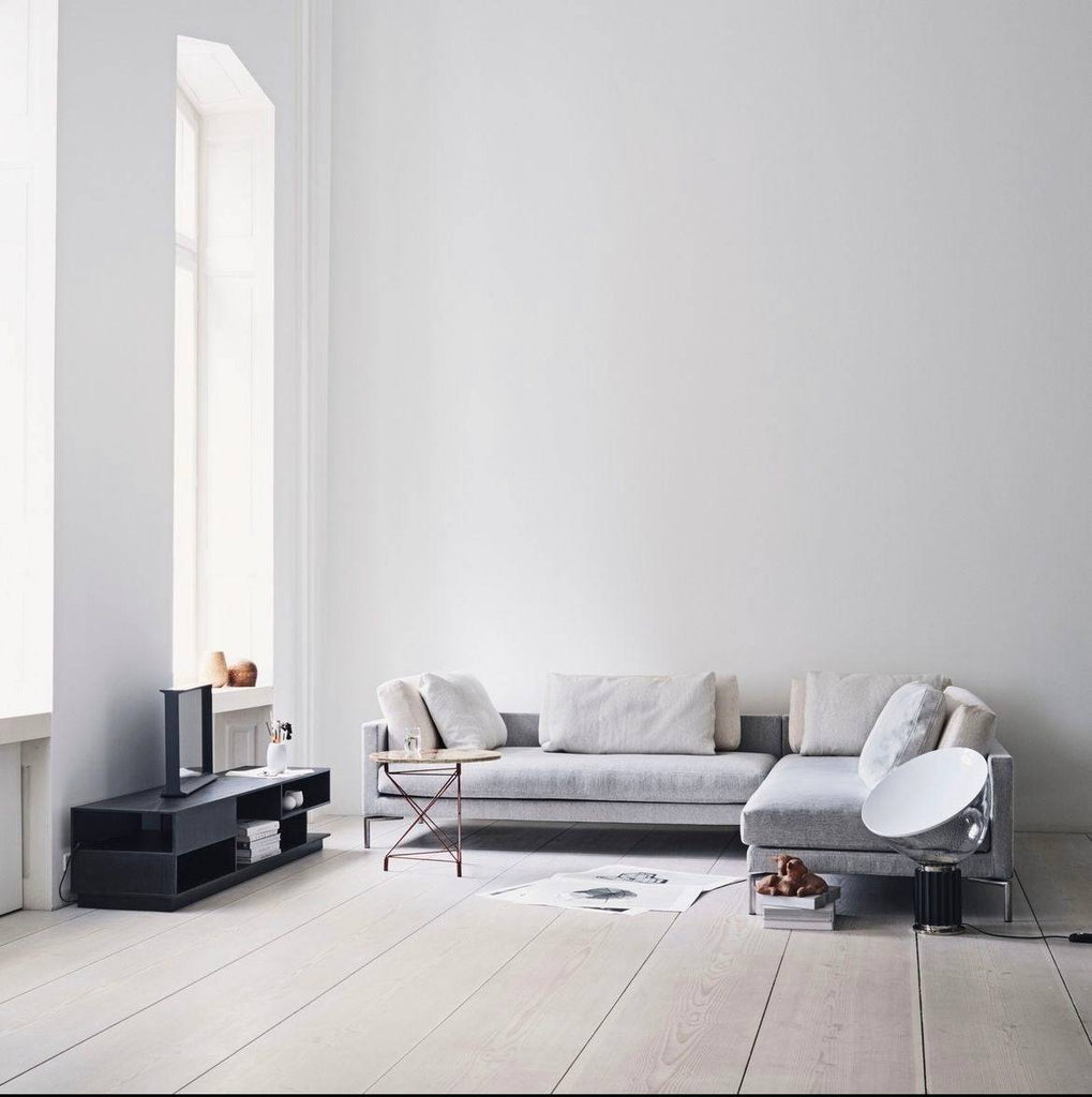 Eilersen Plano Sectional Sofa in Herring 07 fabric styled in a minimalist living room with light wood floors and neutral decor.