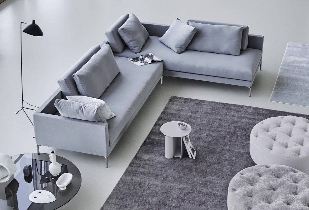 Top view of Eilersen Plano Sectional Sofa in Herring 07 on a grey rug, showcasing its L-shape and plush back cushions.