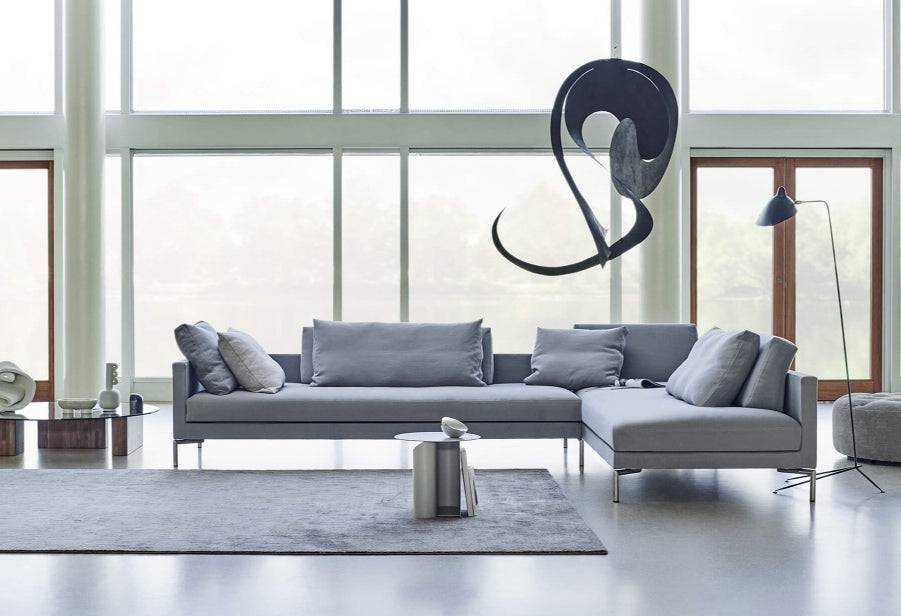 Eilersen Plano Sectional Sofa in a bright, modern living room with sculptural art and floor lamp, perfect for contemporary interiors.