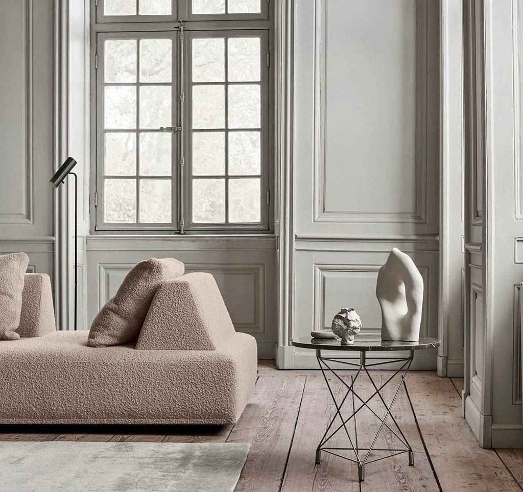 Eilersen Playground Sofa in beige boucle fabric with removable cushions, placed in a refined interior with paneled walls.