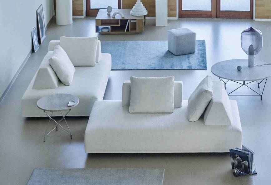 Eilersen Playground Sofa in white fabric set in a modern living room with blue accents and minimalist decor.