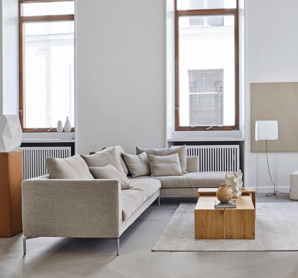 Quick Ship Ra Sectional by Eilersen in light beige fabric, styled in a modern living room with wood accents and neutral decor.