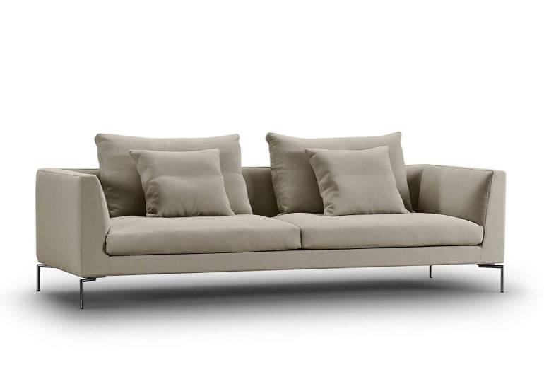 Ra Sectional Sofa by Eilersen in a neutral fabric, designed with plush back cushions and sleek lines for a refined living space.