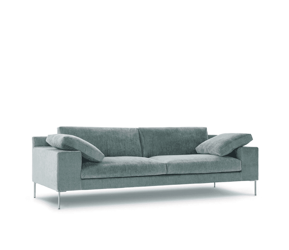 Angled view of Shu Sofa by Eilersen showcasing its minimalist design, distinctive armrests, and textured blue fabric for modern living spaces.