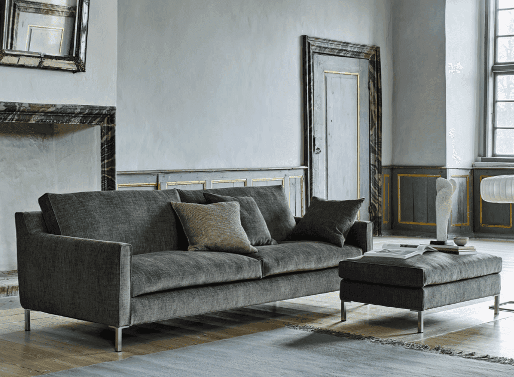 Streamline Sofa by Eilersen at Trade Source Furniture in dark grey fabric with matching ottoman, styled in a vintage-inspired living room.