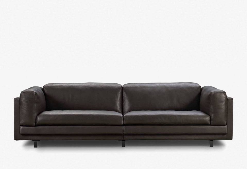 Eilersen Tub Sofa in dark brown leather, front view highlighting its luxurious texture and contemporary design.