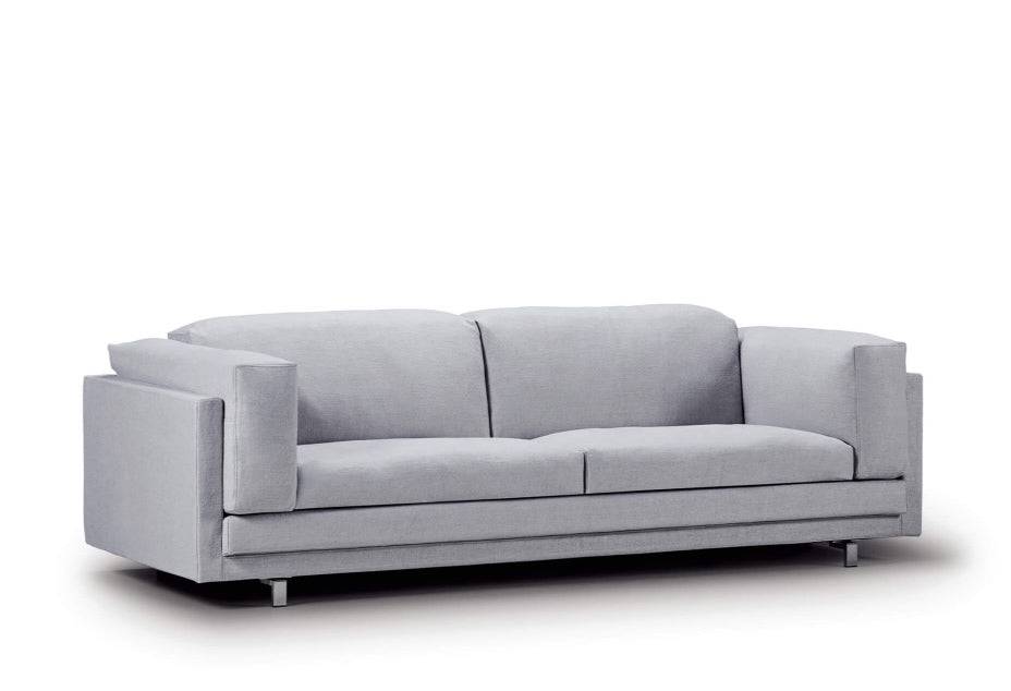 Angled view of the Tub Sofa by Eilersen in light grey fabric, showcasing its structured arms and soft seating.