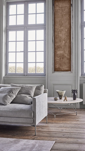 Close-up of Ash Custom Fit Sofa by Eilersen in grey upholstery, showcasing its clean lines and soft cushions at Trade Source Furniture.