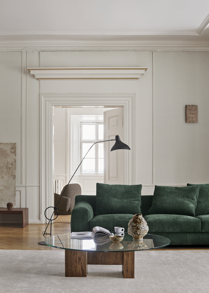 Green Aton Mini Sofa by Eilersen styled with a glass coffee table and floor lamp in a refined living space. Ideal for upscale, space-conscious homes.