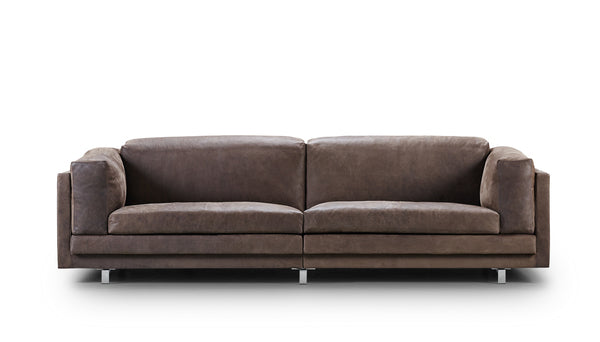 Front view of the brown leather Eilersen Tub Sofa, featuring deep cushions and sleek legs for a luxurious look.