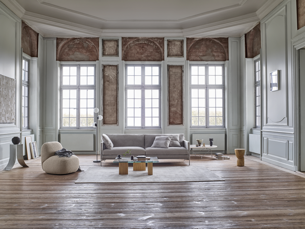 Ash Sofa by Eilersen in a spacious room with high ceilings and rustic decor, available at Trade Source Furniture in custom finishes.
