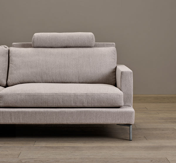 Close-up of The Great Lift Sofa by Eilersen at Trade Source Furniture, highlighting its plush cushions, textured fabric, and metal legs.