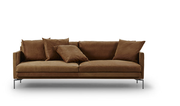 Ash Sofa by Eilersen in warm brown fabric with plush cushions, perfect for cozy living spaces at Trade Source Furniture.