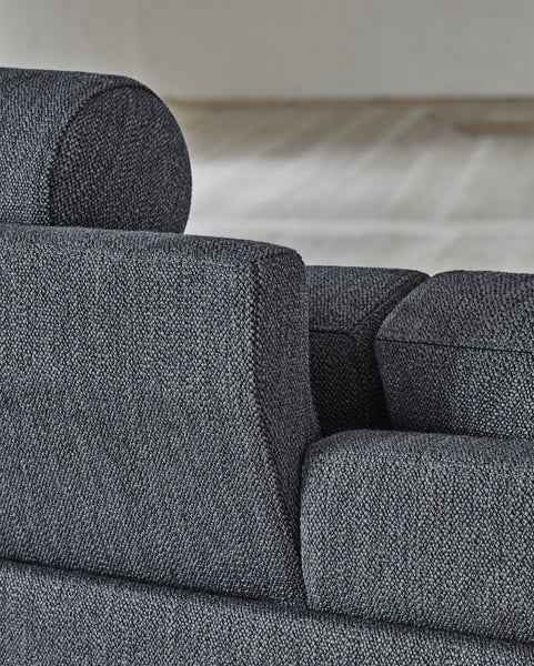 Dark grey fabric version of the Quick Ship Lift Sofa by Eilersen, showcasing textured upholstery and adjustable headrest detail.