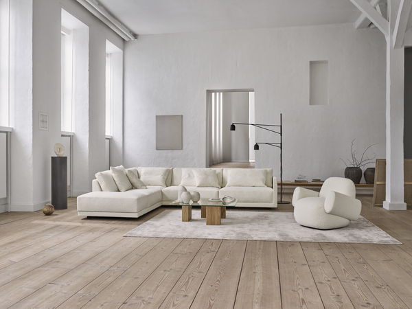 Eilersen Drop Sofa in off-white upholstery, styled in a spacious loft with natural light and contemporary furniture accents.