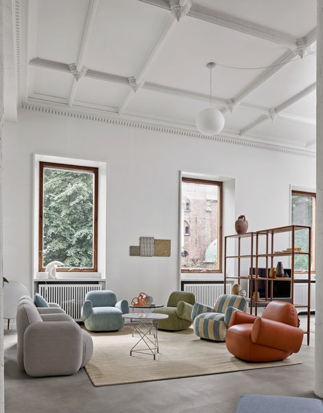 Bright interior with Havana Lounge Chairs by Eilersen in green boucle, styled with a large potted plant and neutral rug.