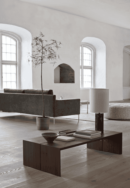 Rear view of Shu Sofa by Eilersen in a serene living space with natural light, showcasing its clean lines and modern silhouette.
