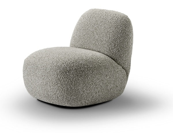 Side profile of Havana Lounge Chair by Eilersen in beige boucle, emphasizing its sculptural and ergonomic design.