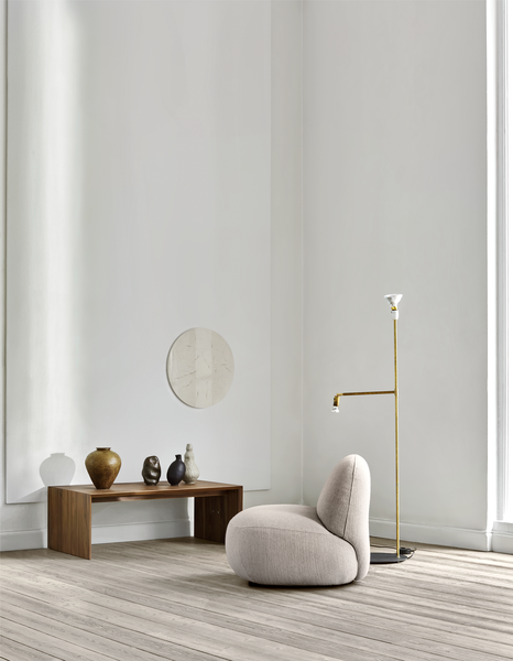 Colorful living room featuring Havana Round Arm Chair by Eilersen in yellow velvet, styled with a green sectional sofa.