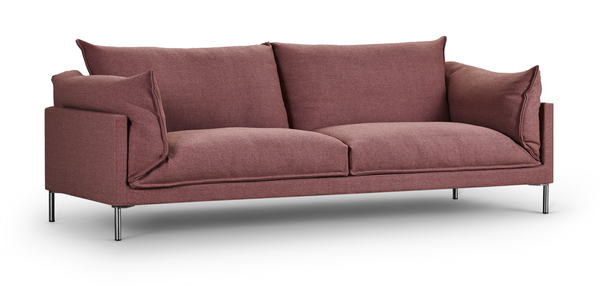 Isolated view of Butterfly Sofa by Eilersen in rose fabric with slim metal legs, emphasizing its sleek, contemporary silhouette.