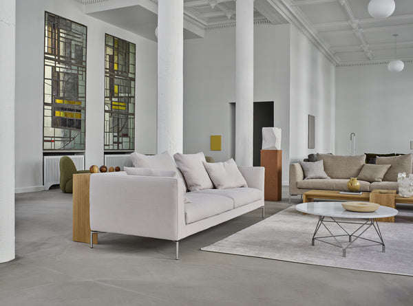 Eilersen Ra Sofa in Gravel 7 fabric displayed in a spacious showroom with minimalist decor, part of the Quick Ship collection at Trade Source Furniture.