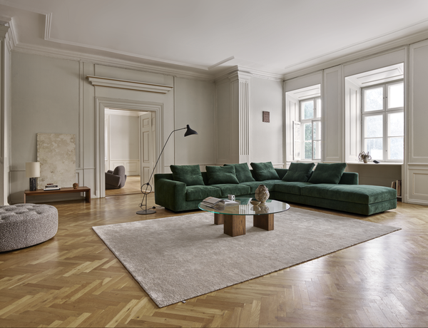 Full room view featuring the Aton Mini Sofa by Eilersen in green, paired with minimalist decor and a neutral rug. Stylish comfort in a compact form.
