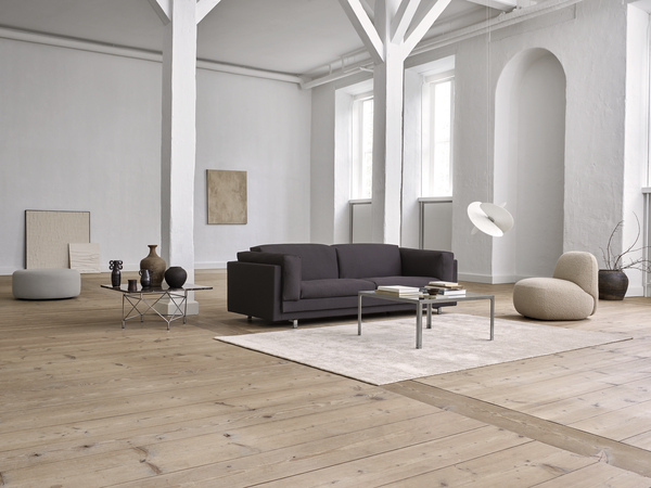 Tub Sofa by Eilersen in a spacious modern living room, styled with neutral decor and natural wood flooring at Trade Source Furniture.