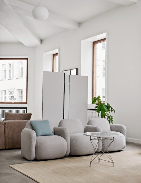 Havana Round Arm Chair and ottoman by Eilersen in light grey fabric, shown together for a cohesive lounge furniture set.