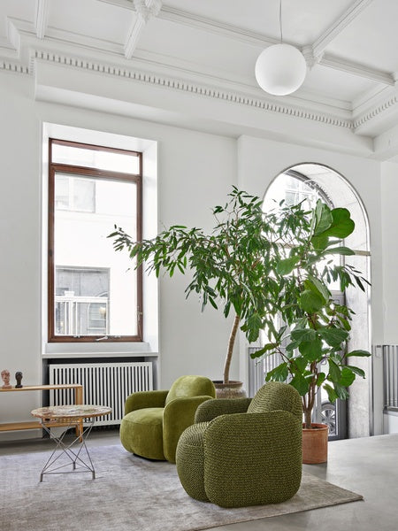 Minimalist living room featuring Havana Lounge Chairs by Eilersen in light grey, styled with a beige rug and modern accents.