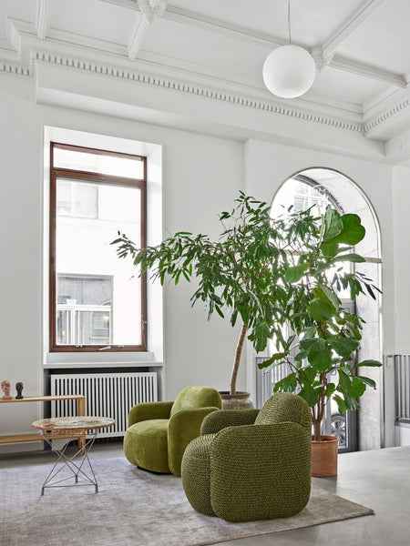 Minimalist living room featuring Havana Lounge Chairs by Eilersen in light grey, styled with a beige rug and modern accents.