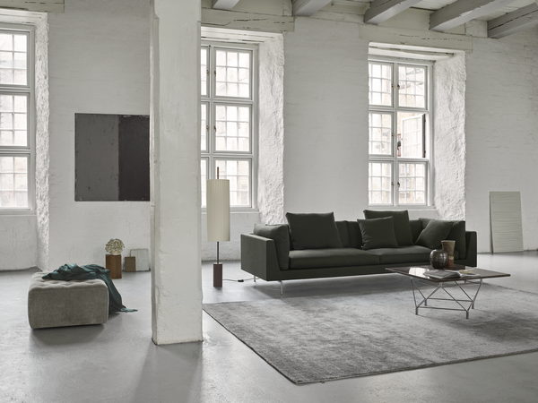 Wide view of Float High Sectional Sofa by Eilersen in a spacious modern room with large windows and minimalist furnishings.