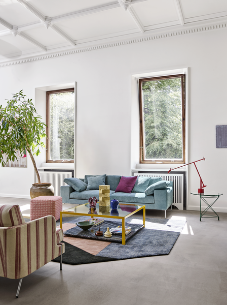 Shu Sofa by Eilersen in light blue fabric styled in a modern living room with colorful decor and large windows, part of luxury furniture collection.