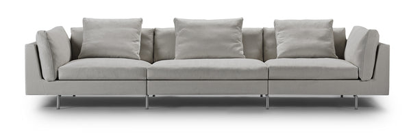 Front view of Float High Sectional Sofa by Eilersen in light grey upholstery with modular design and plush back cushions.