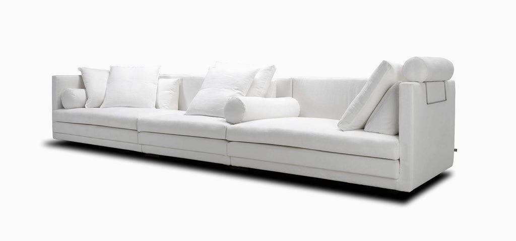 Cocoon Sofa by Eilersen at Trade Source Furniture in white fabric, featuring modular design with back roll and multiple cushions on a white background.