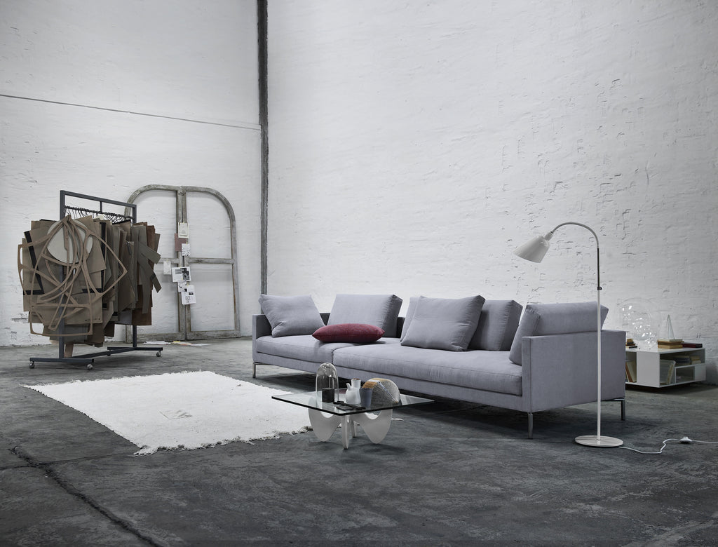 Eilersen Plano Sectional Sofa in industrial-style room with concrete floors and modern lighting, upholstered in Herring 07.
