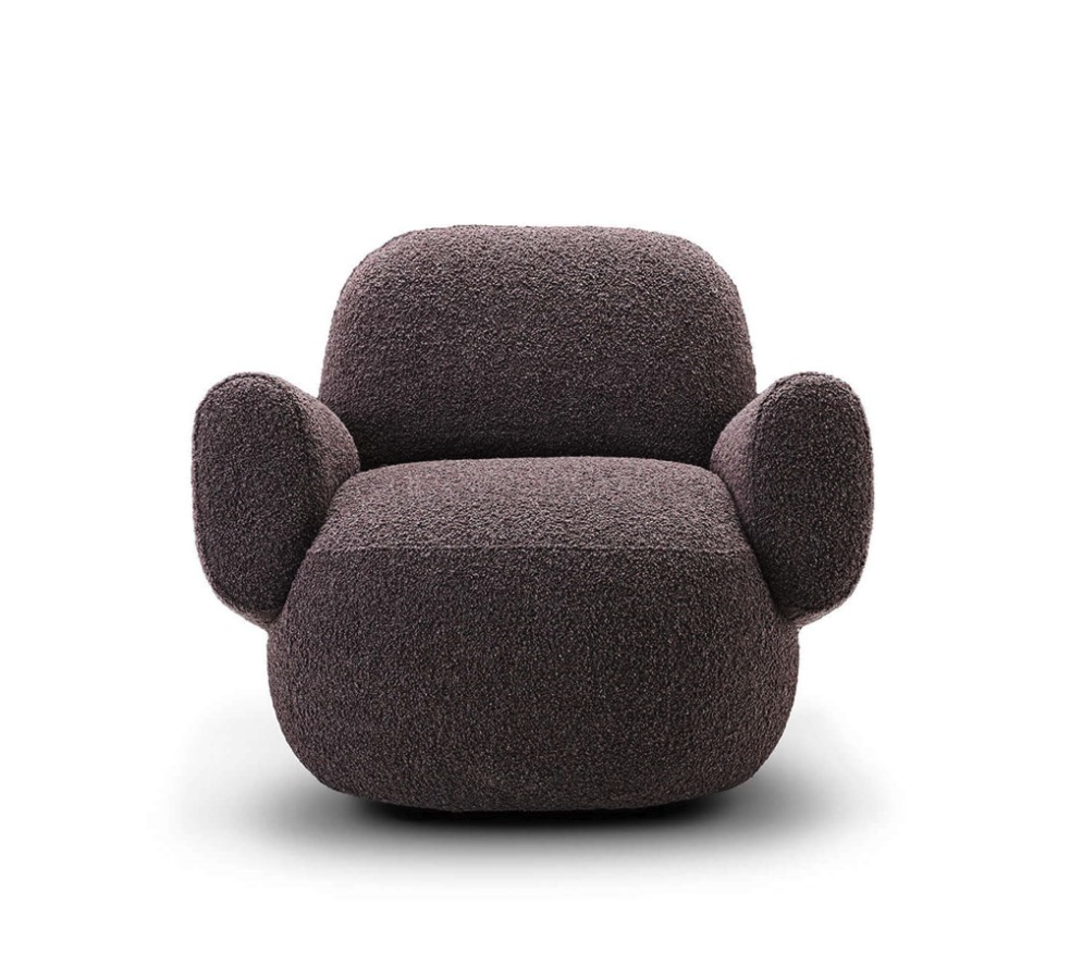 Front view of Havana Lounge Chair by Eilersen in green velvet, featuring a rounded back and seat for modern comfort.