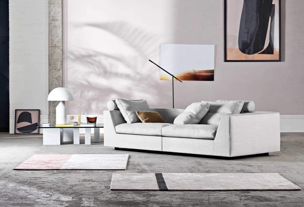 Front view of Chess Sofa by Eilersen in light beige fabric with two large back cushions, showcasing its clean modern lines.