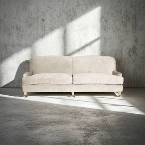 Beige sofa in a room with concrete walls and floor
