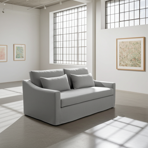 Gray sofa in a room with large windows and minimal decor