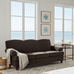Brown sofa in a room with large windows and beach view