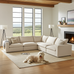 Beige sectional sofa in a living room with a dog lying on the floor.