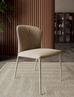 Elegant beige upholstered dining chair with slender metal legs, ideal for modern kitchen or dining room settings