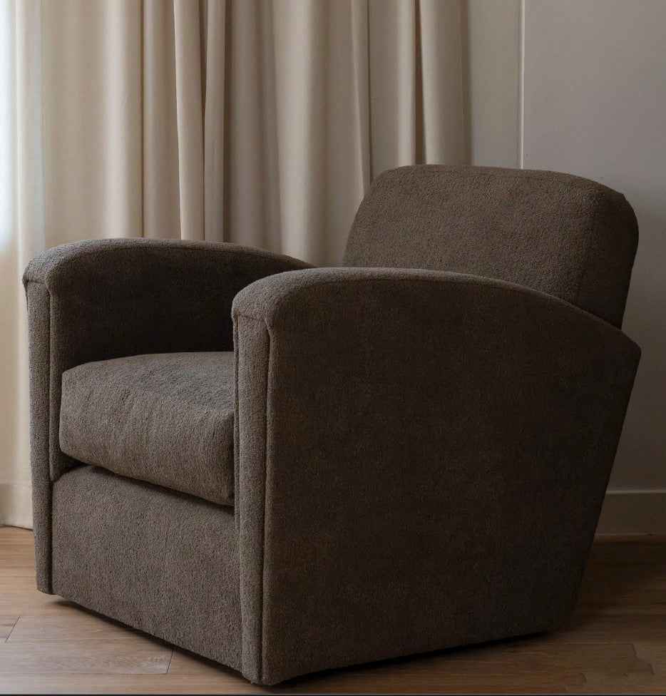 Brown armchair in a room with beige curtains